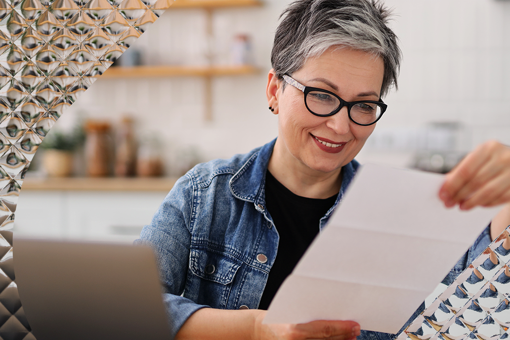 Image of an older woman looking at a paper bill